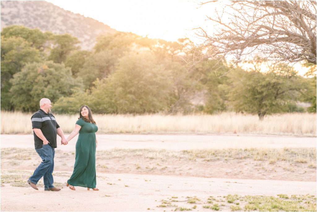 Couple walking together in open field at engagement session in Sierra Vista, AZ