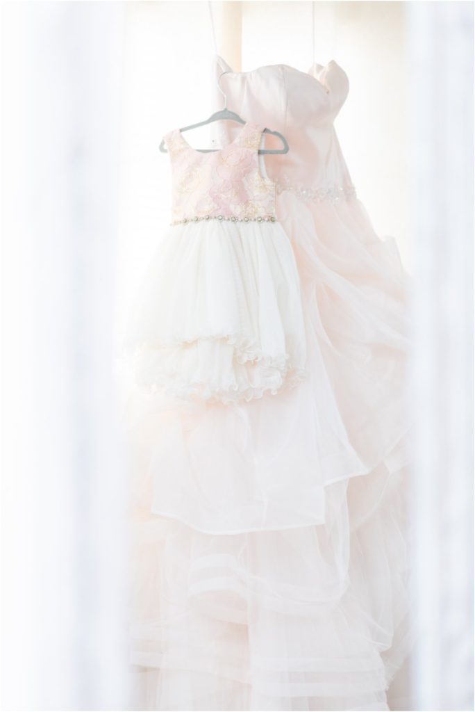 bride's and flower girl's dress hanging