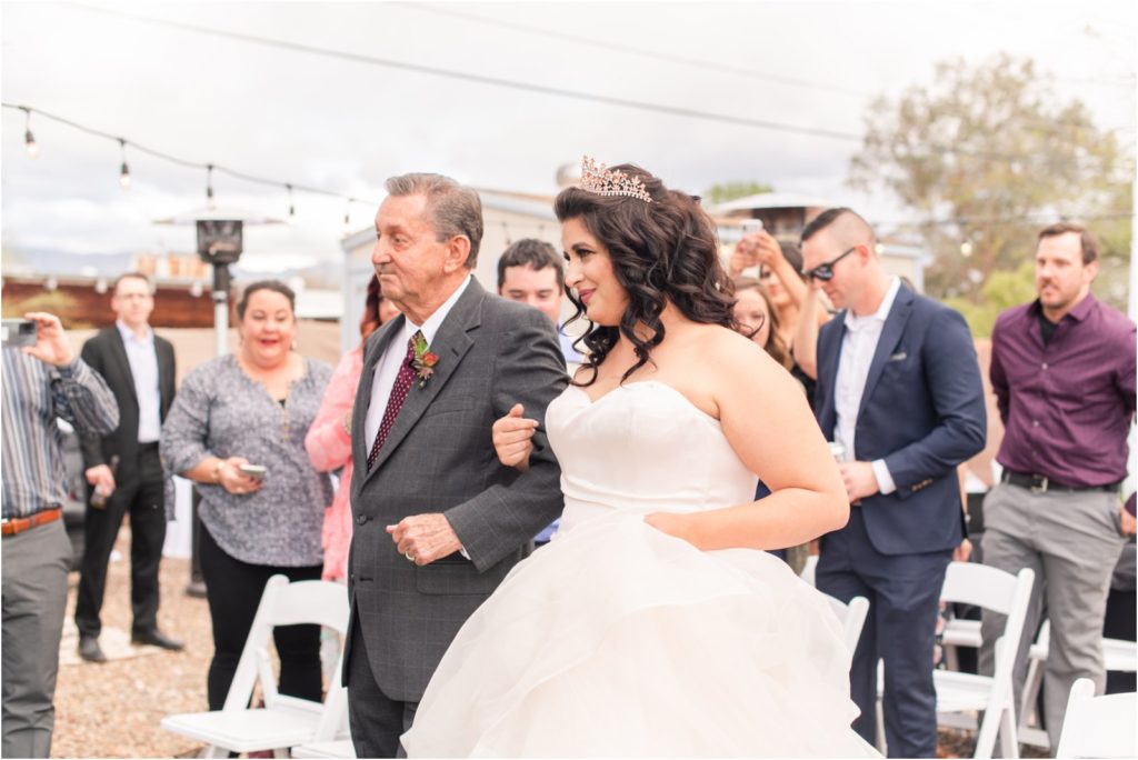 bride walking down the aisle with her grandpa