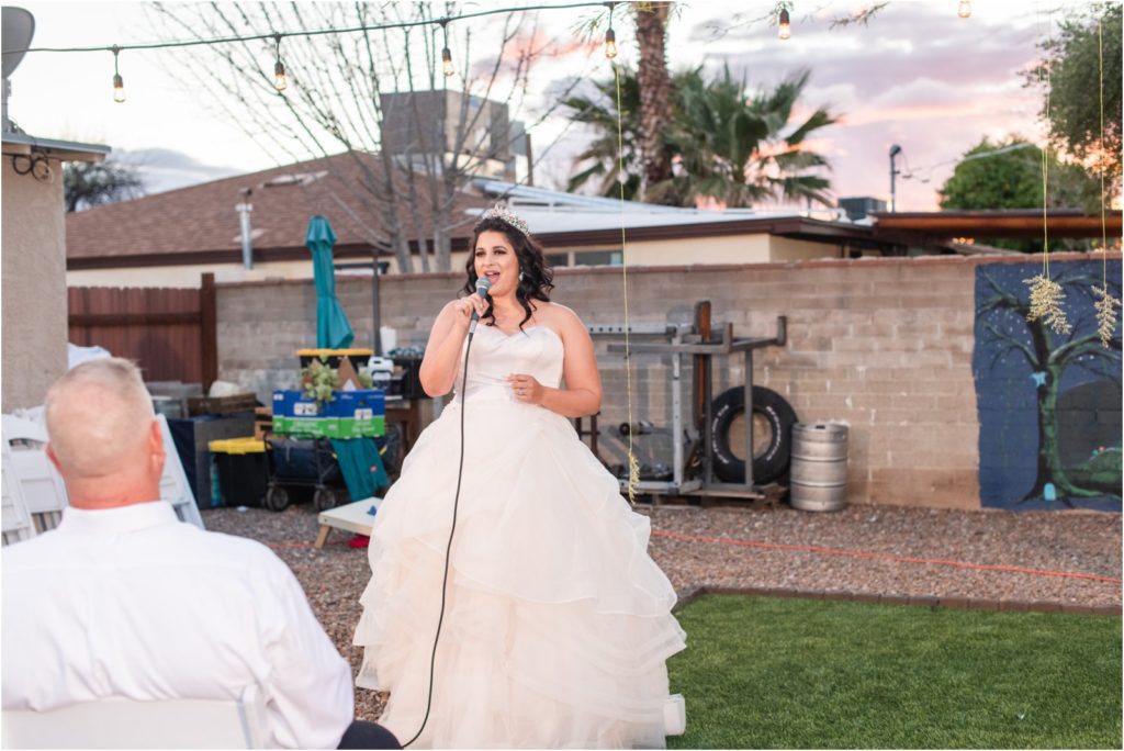 bride singing to groom at vow renewal