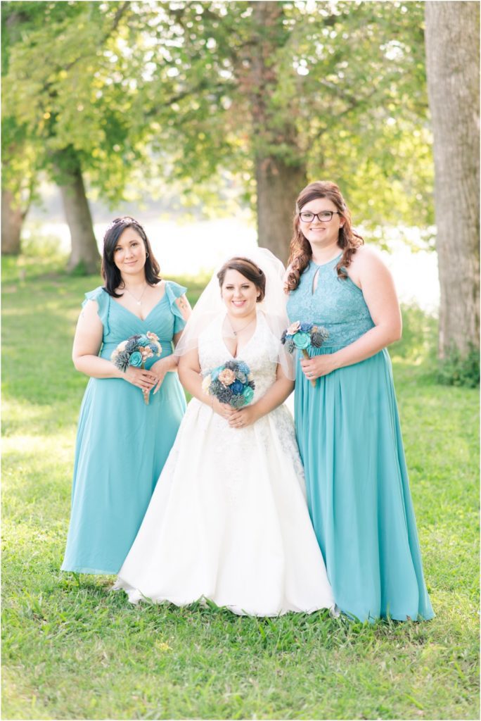 bride and bridesmaids in teal dresses at Freedom Point