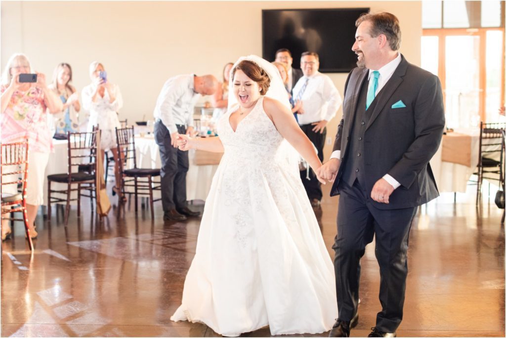 happy bride entering reception dancing