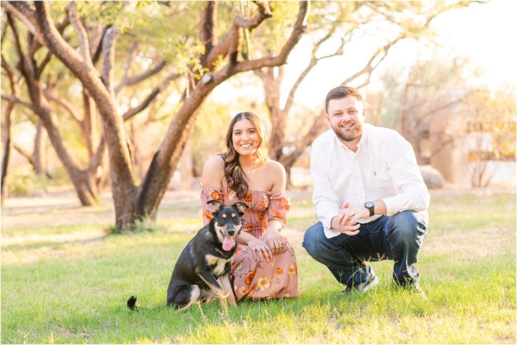 engaged couple smiling with puppy in Tucson for engagement session