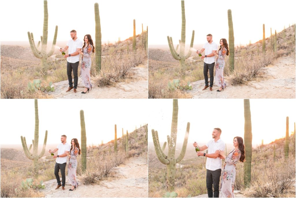 engaged couple popping champagne to celebrate engagement in Tucson desert on mountainside