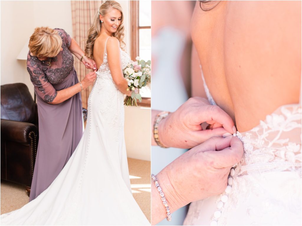 mother of the bride helping her daughter into her wedding dress