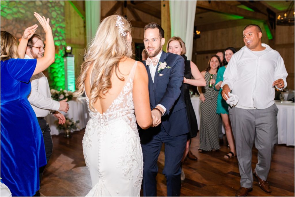 couple dancing at reception with colorful lights