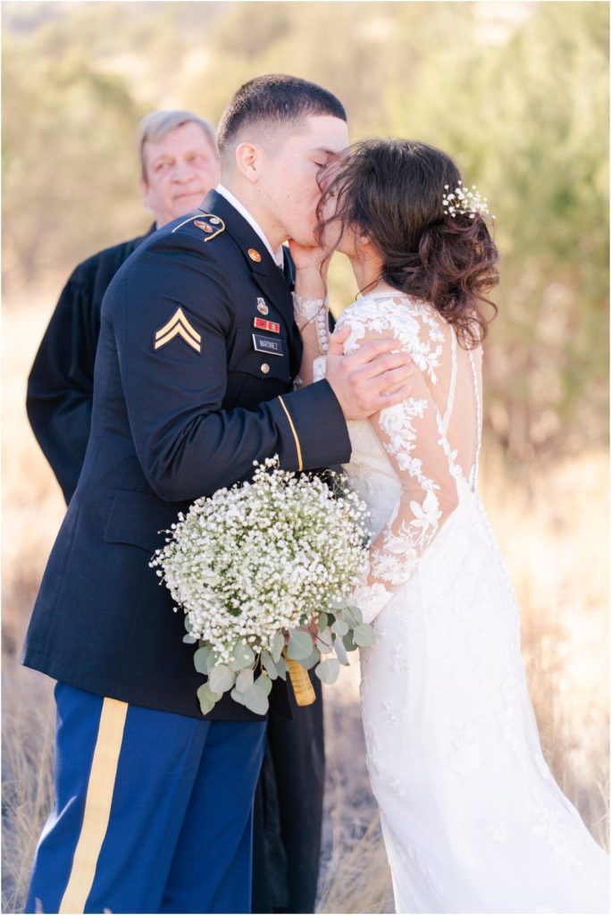bride and groom first kiss at end of wedding ceremony