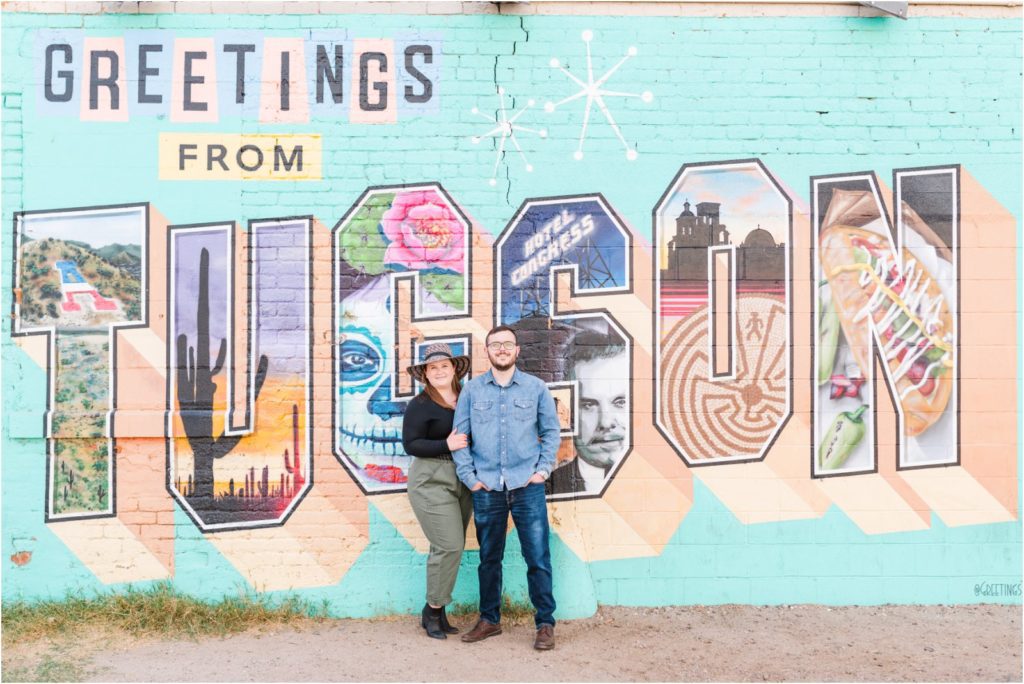 couple in front of Tucson Greeting mural