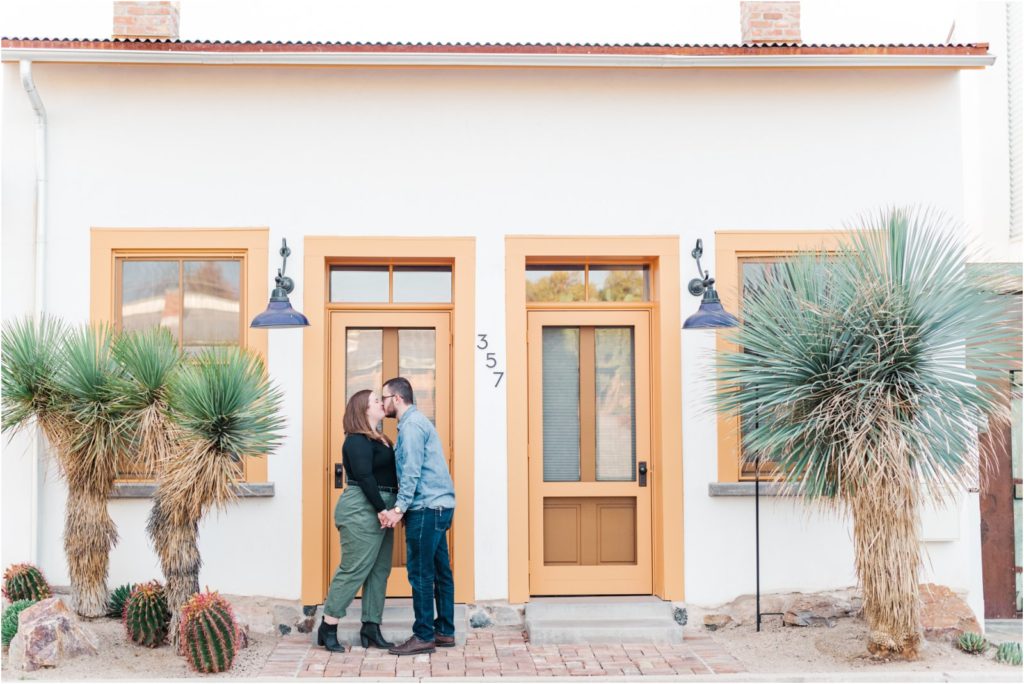 couple kissing in doorway in downtown Tucson