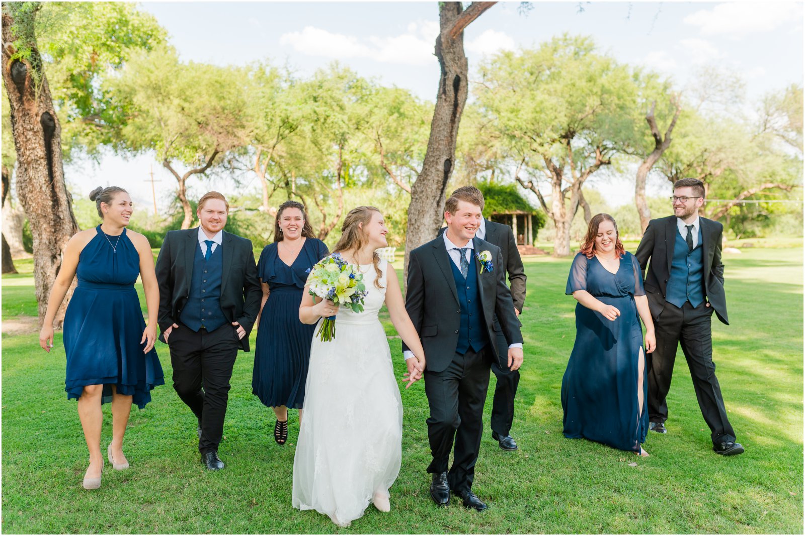bridal party walking together on lawn at La Mariposa Tucson