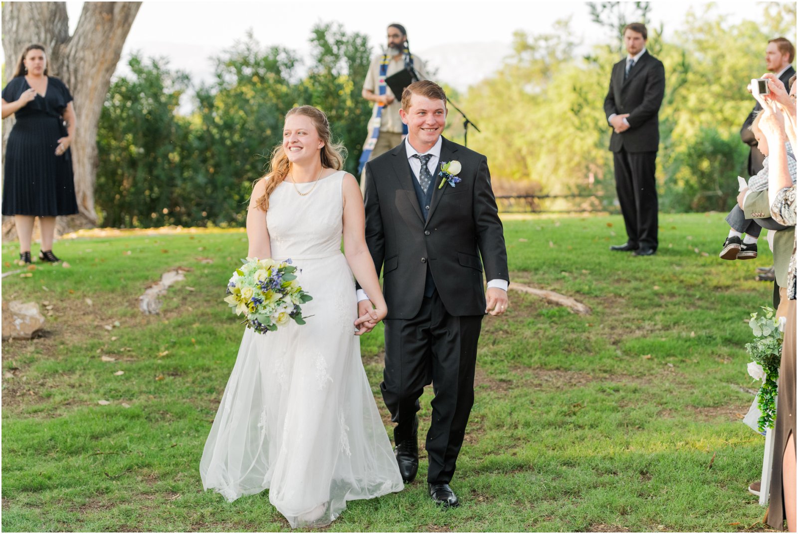 bride and groom walking down aisle together after ceremony at La Mariposa Tucson