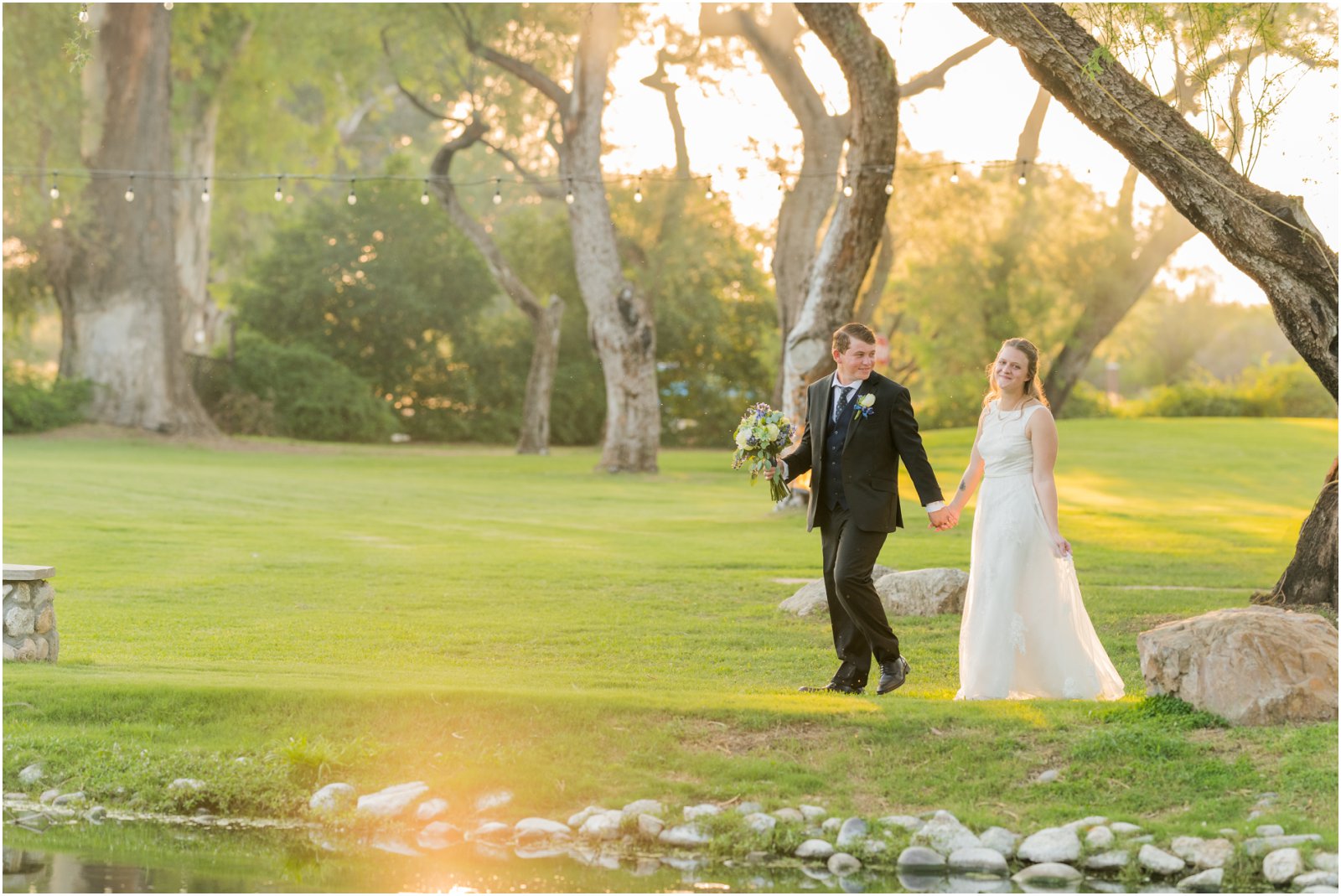 bride and groom walking alongside pond at La Mariposa Tucson by Christy Hunter Photography