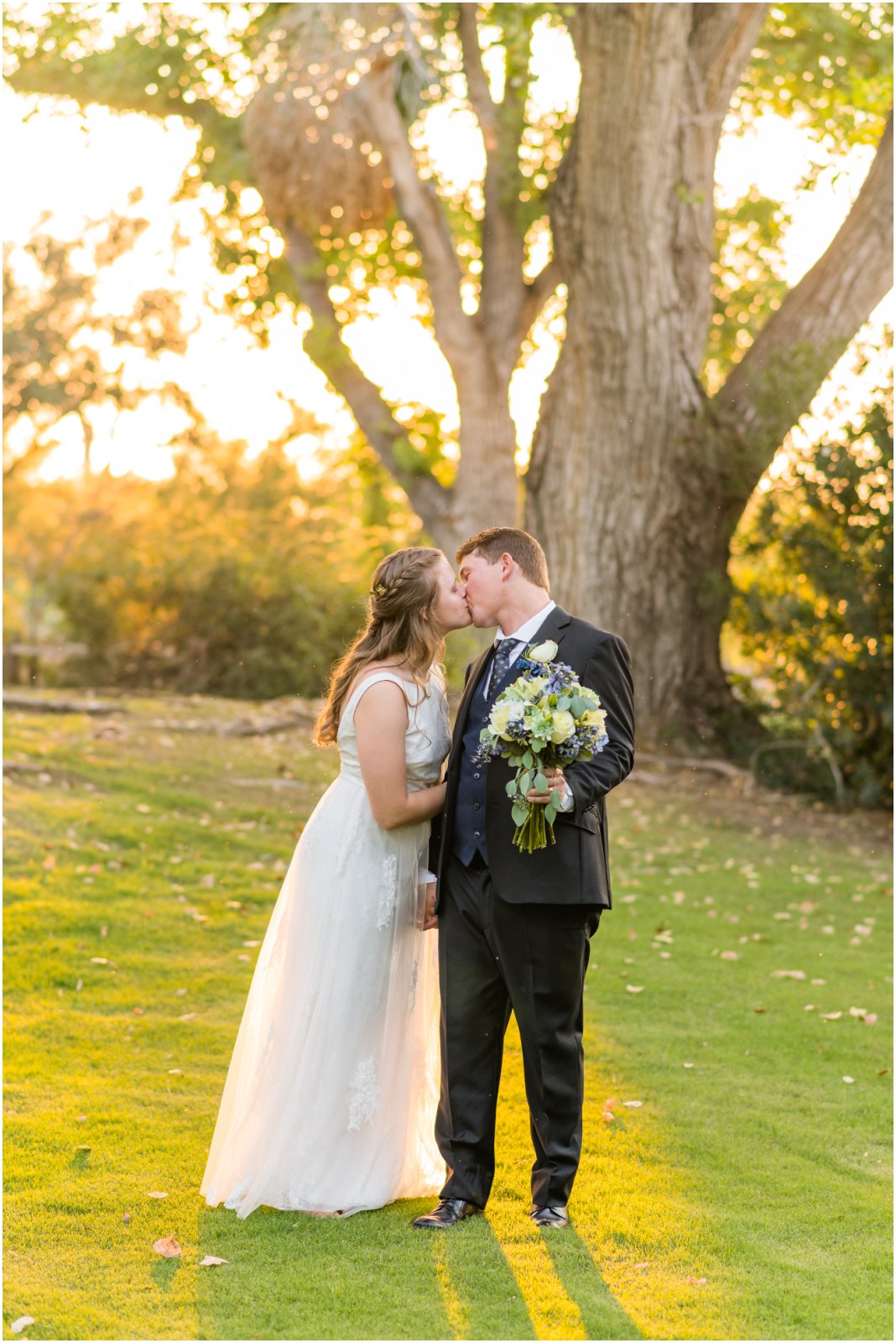 bride and groom kissing on lawn at sunset at La Mariposa Tucson