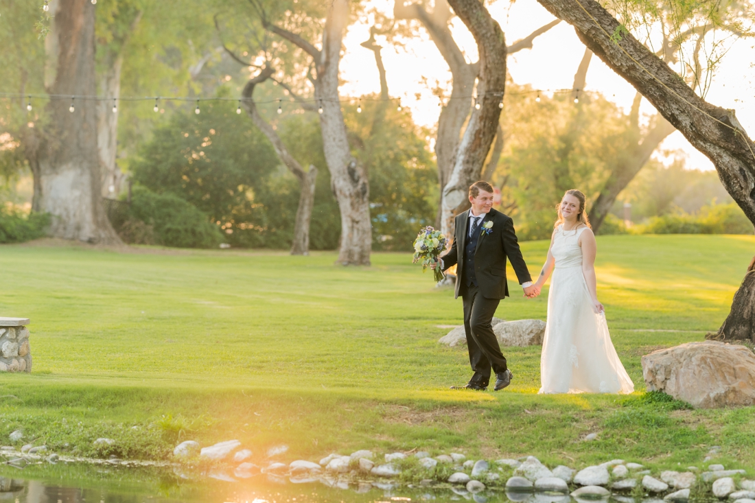 La Mariposa Tucson wedding bride and groom walking by pond by Christy Hunter Photography