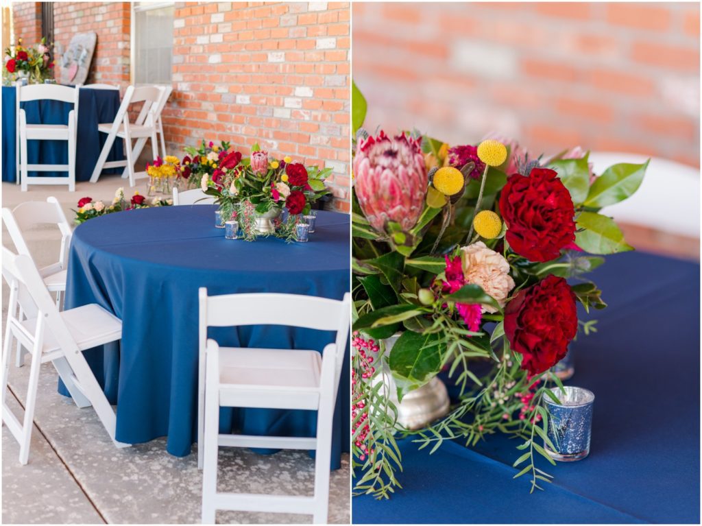 backyard wedding reception tables with navy blue linens