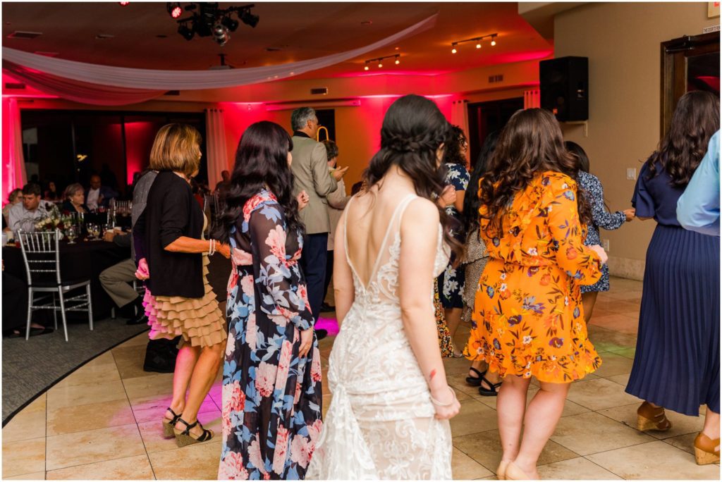 bride dancing with guests during wedding reception
