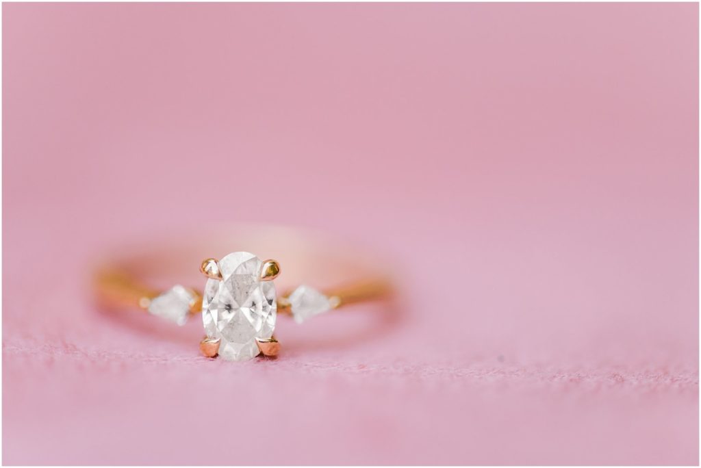 engagement ring on pink suede backdrop