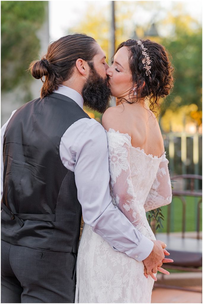 bride and groom kissing right after wedding ceremony