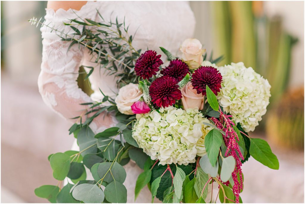 burgundy bridal bouquet and lace dress for winter wedding
