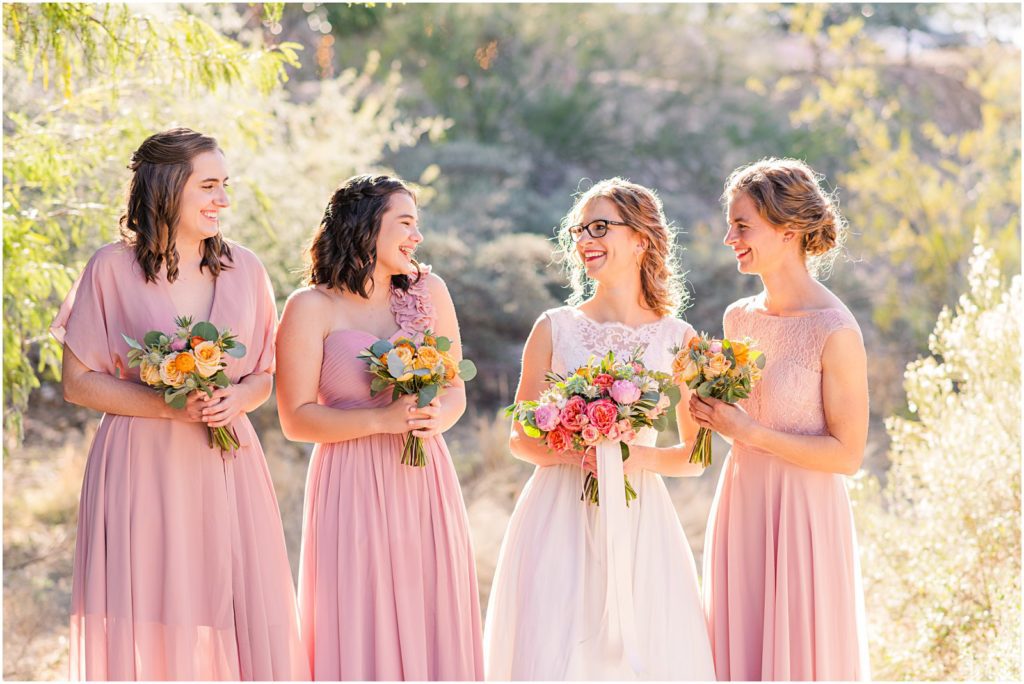 bride and bridesmaids laughing and smiling