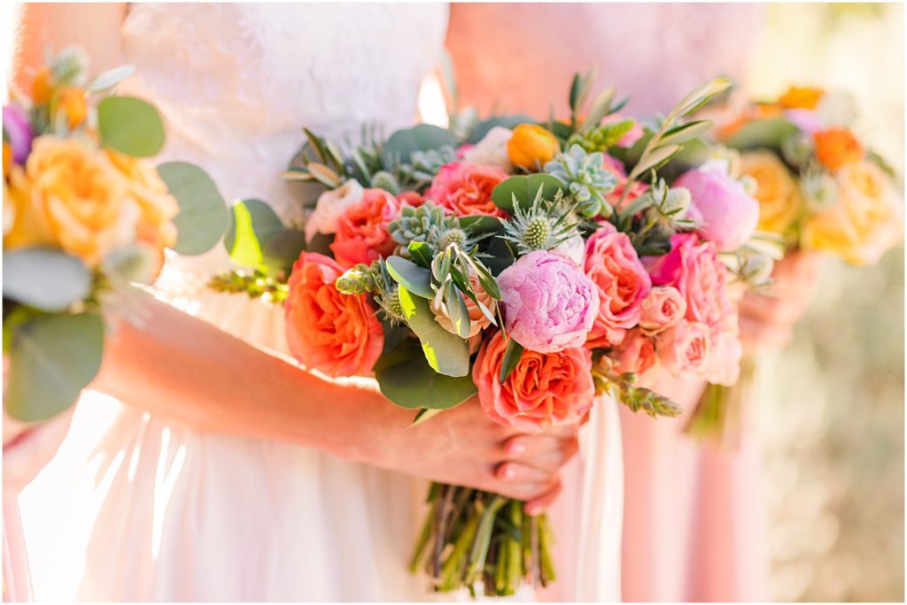 colorful coral bouquet with pink bridesmaid dresses