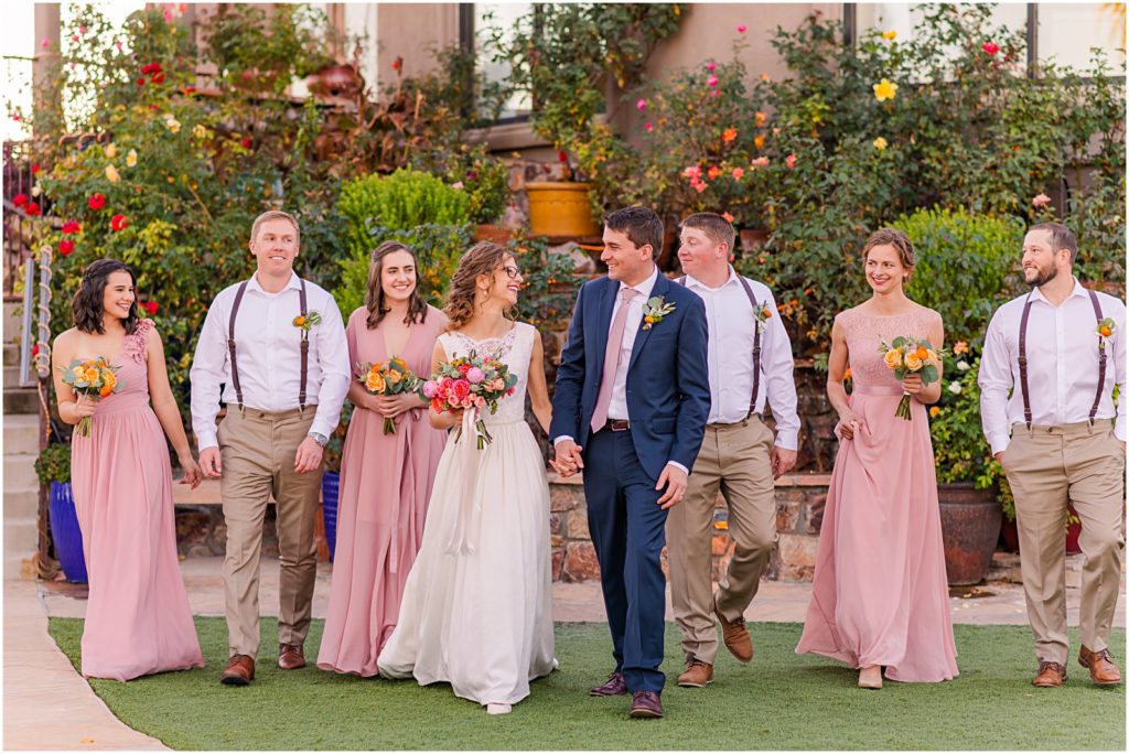 bridal party in navy blue and pink walking together