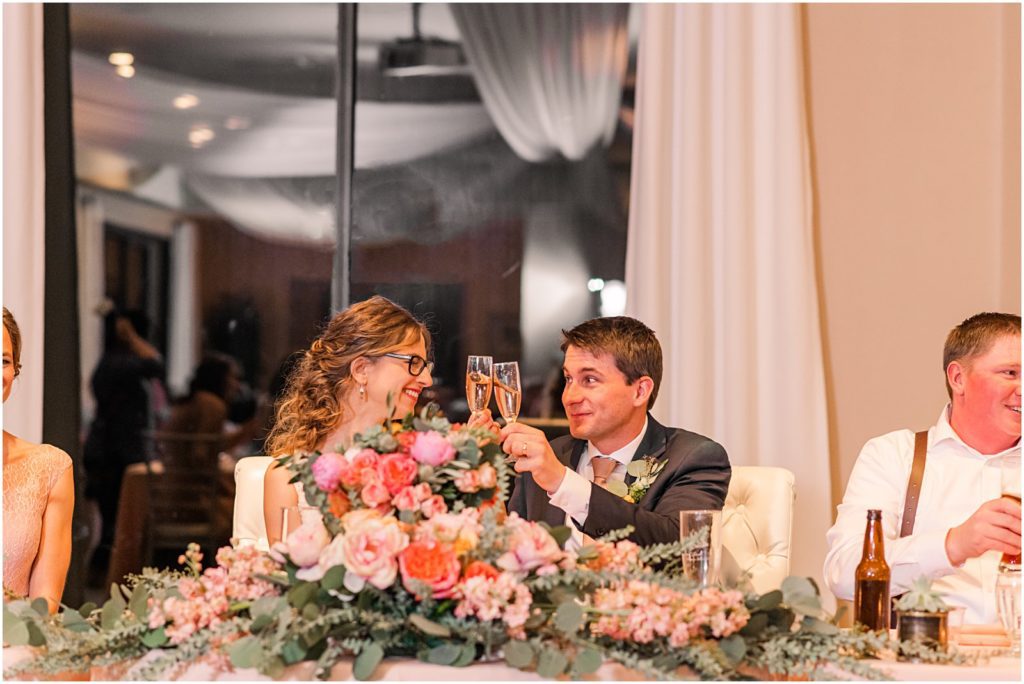 bride and groom cheers with champagne glasses
