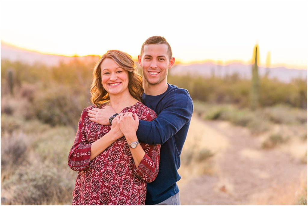engaged couple in desert wearing casual outfits