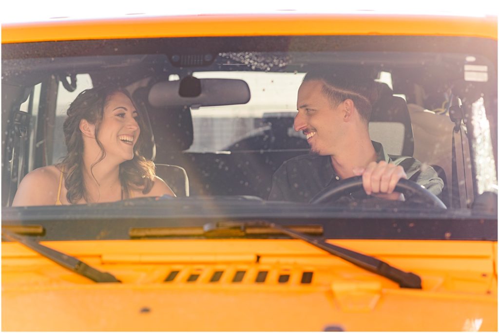 photo of couple in bright yellow jeep laughing