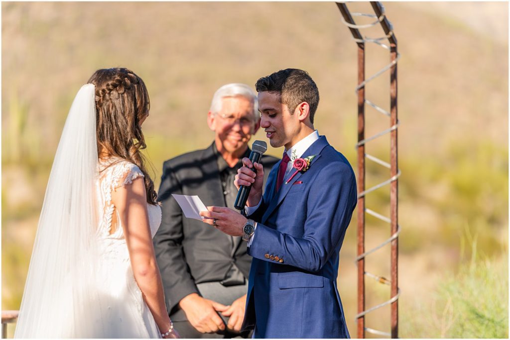 groom reading vows to bride at bright wedding ceremony