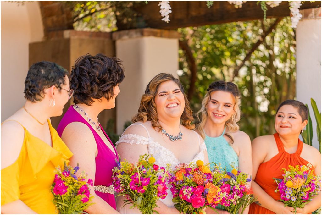 bride smiling and laughing with her bridesmaids
