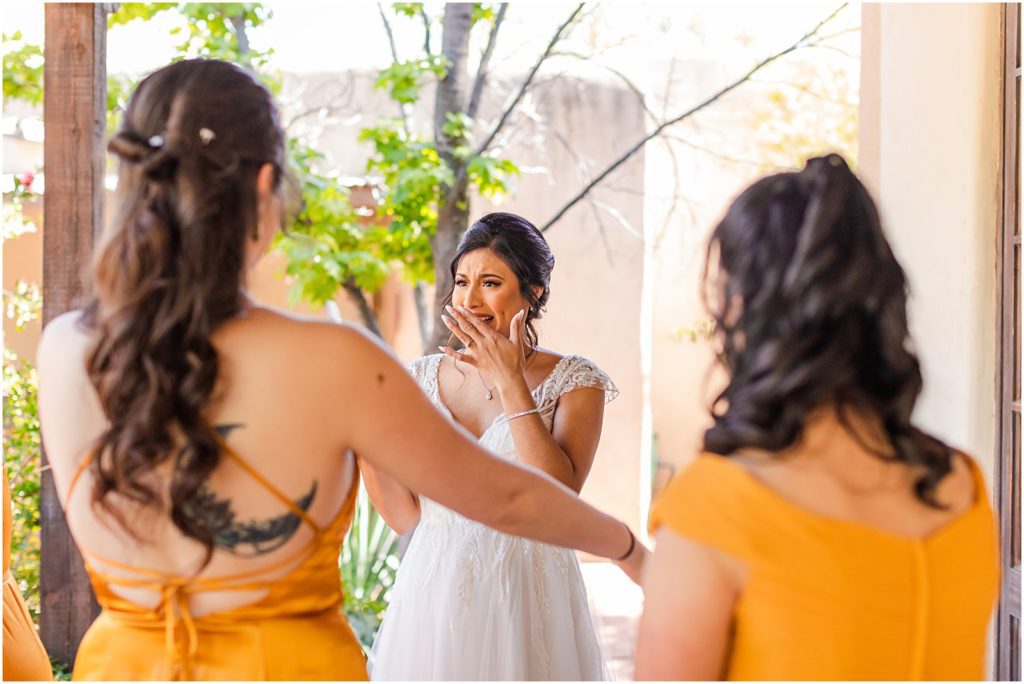 bride crying when seeing bridesmaid cry during First Look