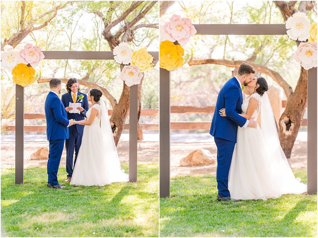 bride and groom kiss under wooden alter during outdoor wedding in Tucson