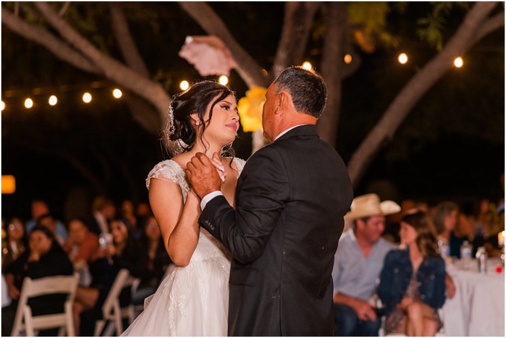 bride dancing with her dad during outdoor reception