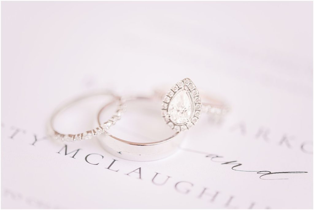 wedding ring set on sophisticated white wedding invitation to Sedona wedding
