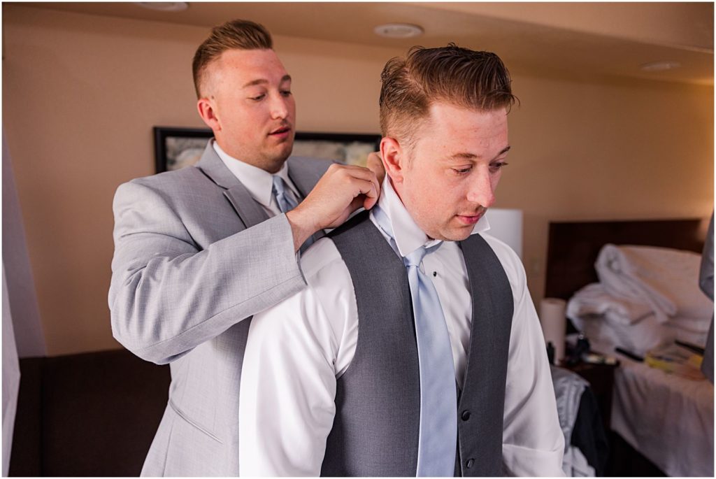 brother helping groom getting ready at The Ridge hotel