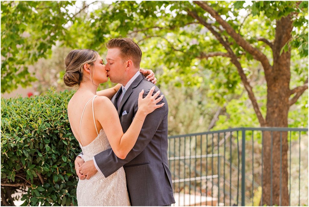 bride and groom kiss among trees at The Ridge hotel