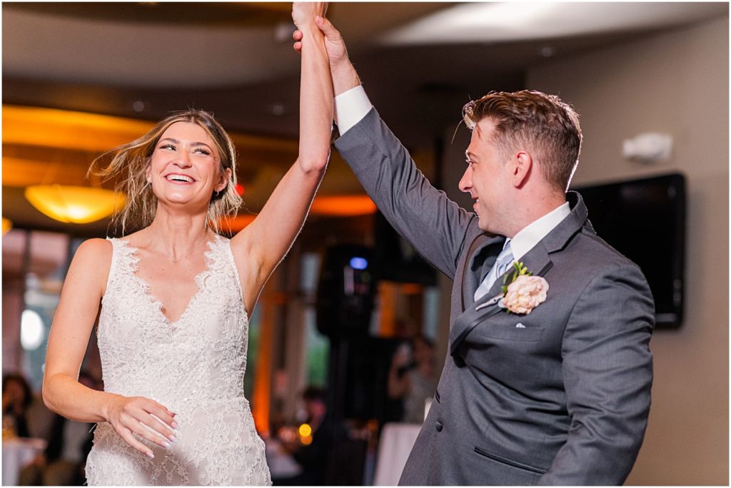 groom twirling bride during dance together at wedding reception