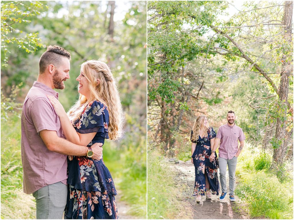 engaged couple walking together on wooded trail