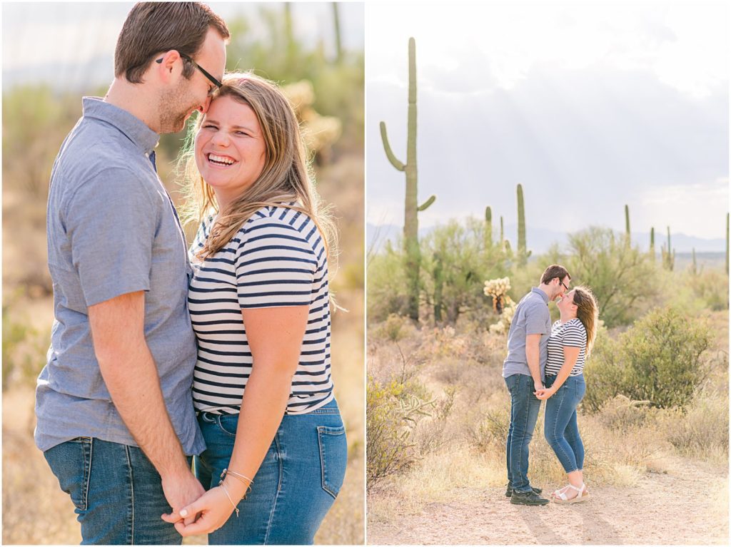 engaged couple in blue jeans kissing in desert