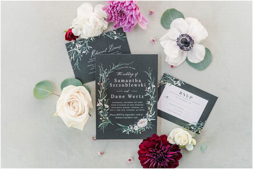 classic wedding invitation suite with wedding flowers around it