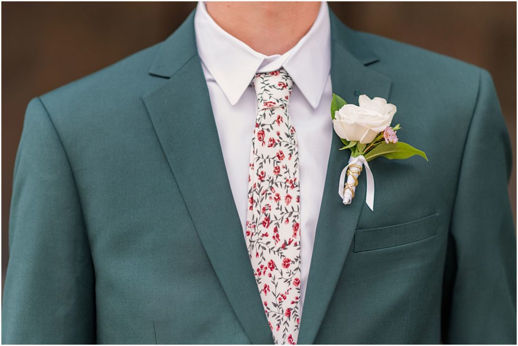 emerald green groom's suit with burgundy floral tie