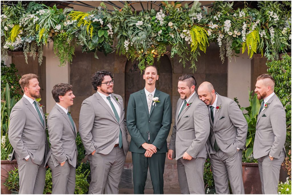 goofy groomsmen laughing at groom