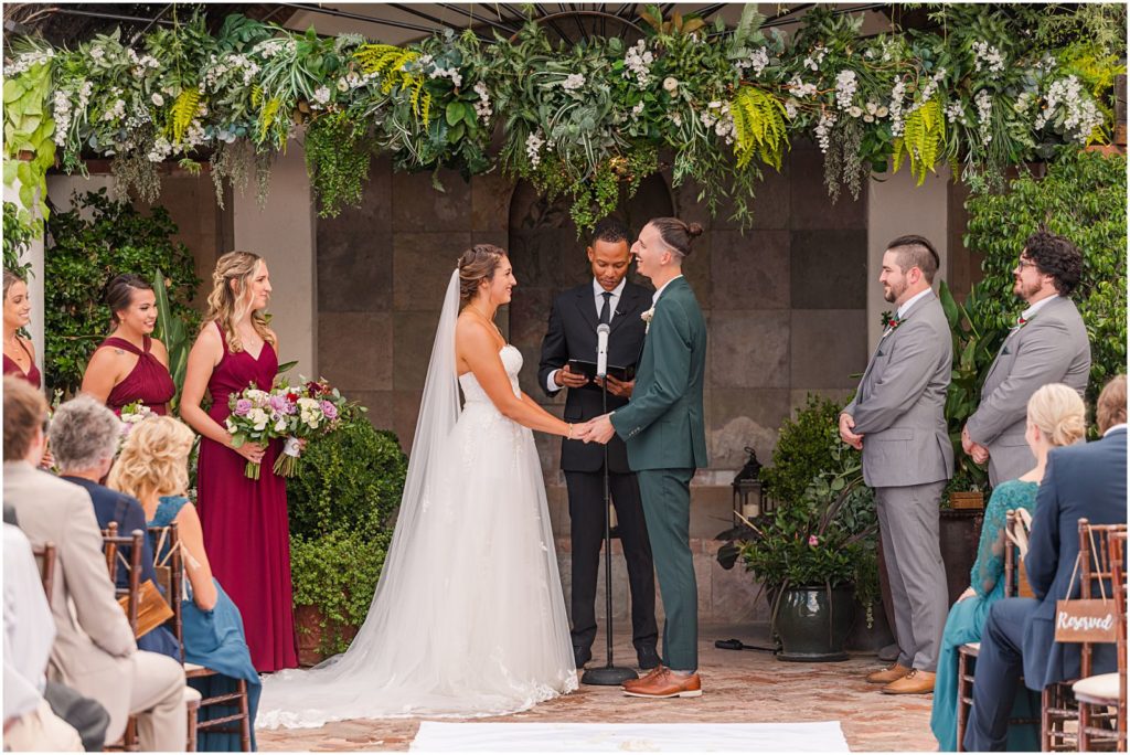 emerald and burgundy wedding ceremony at the Stillwell House