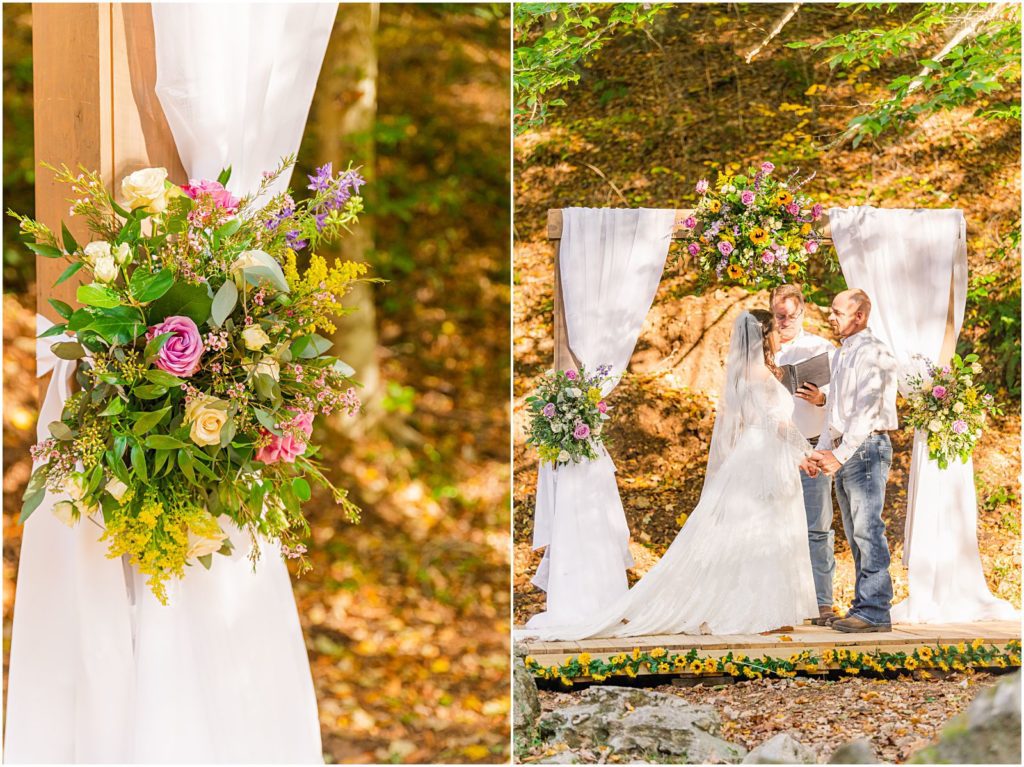 bride and groom under arch in woods at ceremony