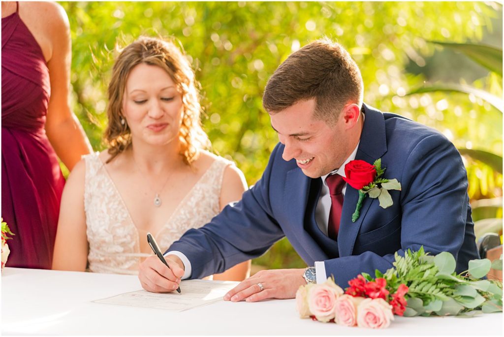 couple signing marriage certain outdoors