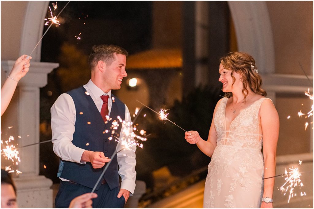 couple holding sparklers at night
