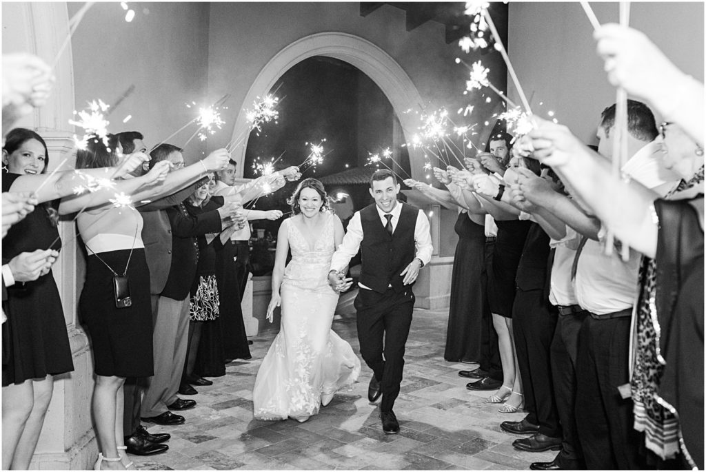 married couple walking through tunnel of sparklers at Westin La Paloma wedding reception