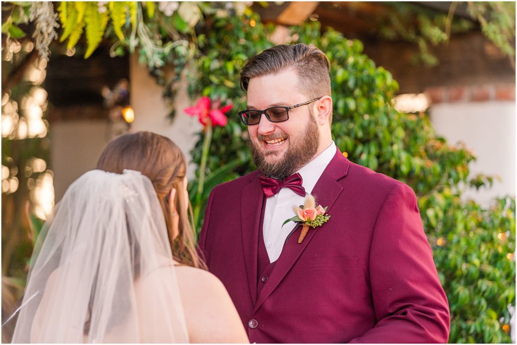groom smiling big as he sees bride for first time at the alter