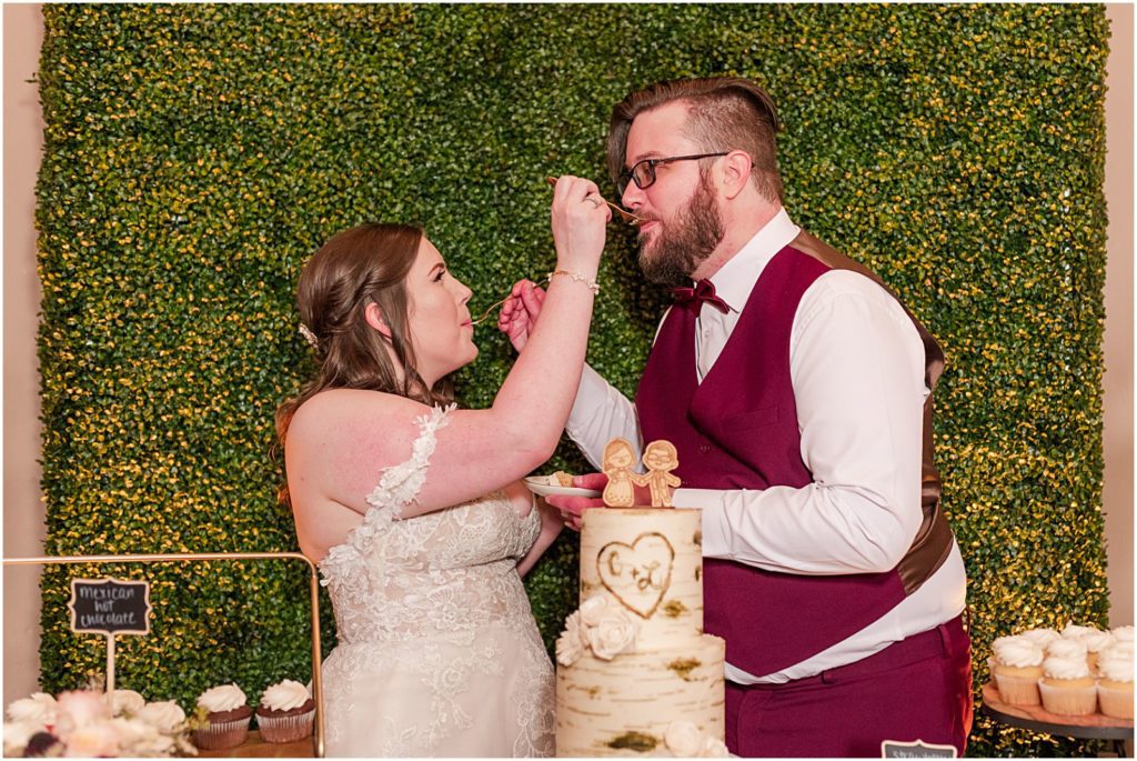 bride and groom feeding each other rum wedding cake